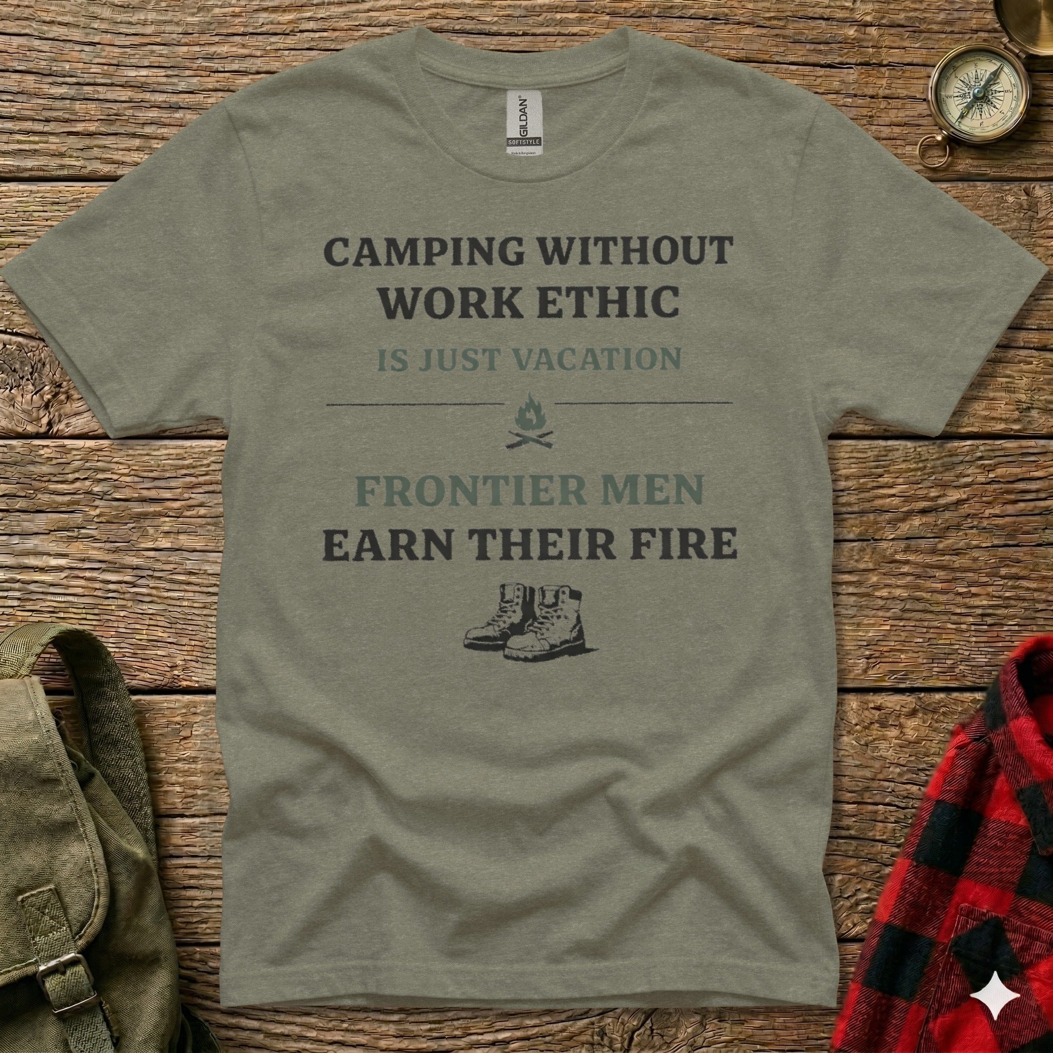Olive green t-shirt with "Camping Without Work Ethic is Just Vacation Frontier Men Earn Their Fire" text and boot graphic.
