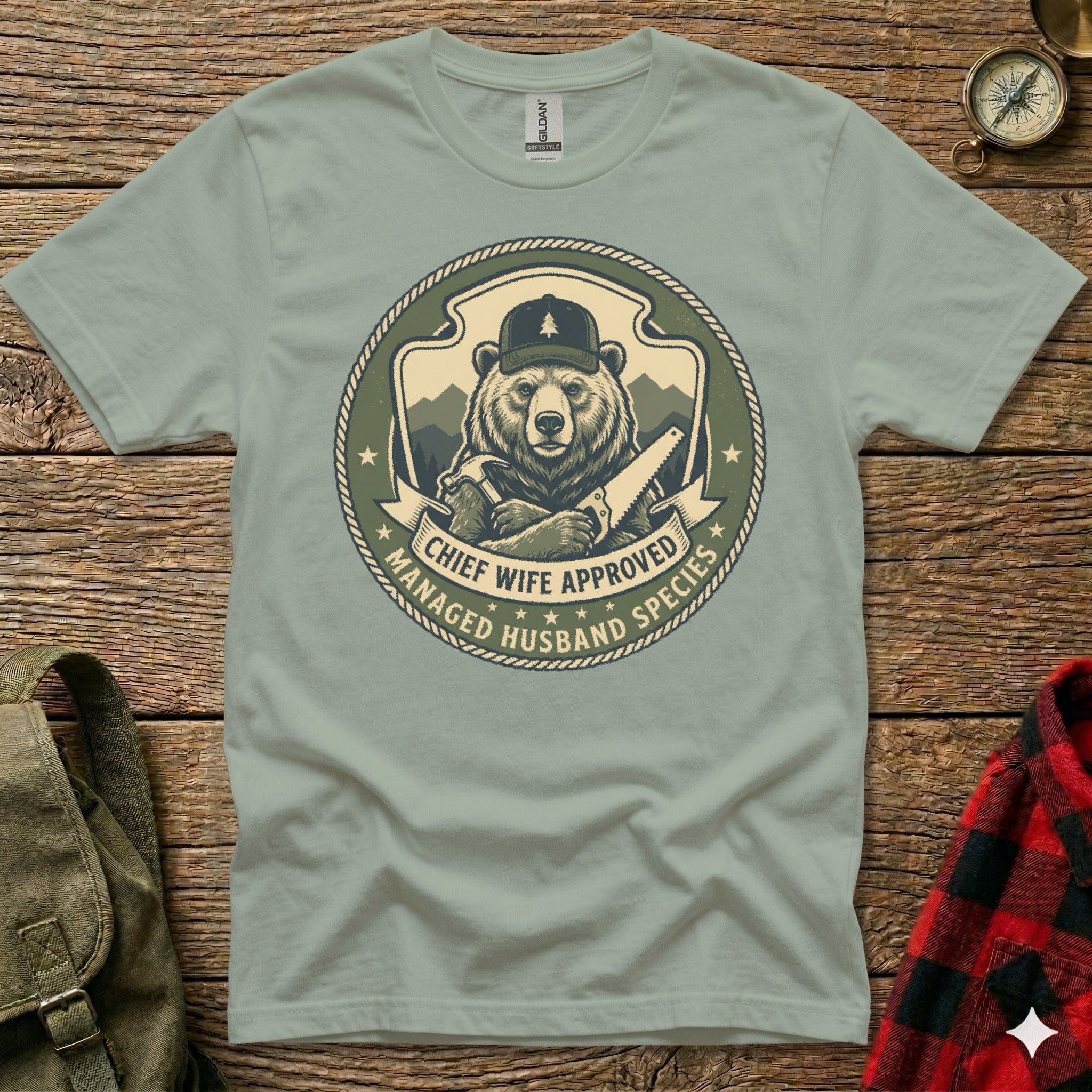 Bear in plaid hat holds saw, "Chief Wife Approved" text on shirt.