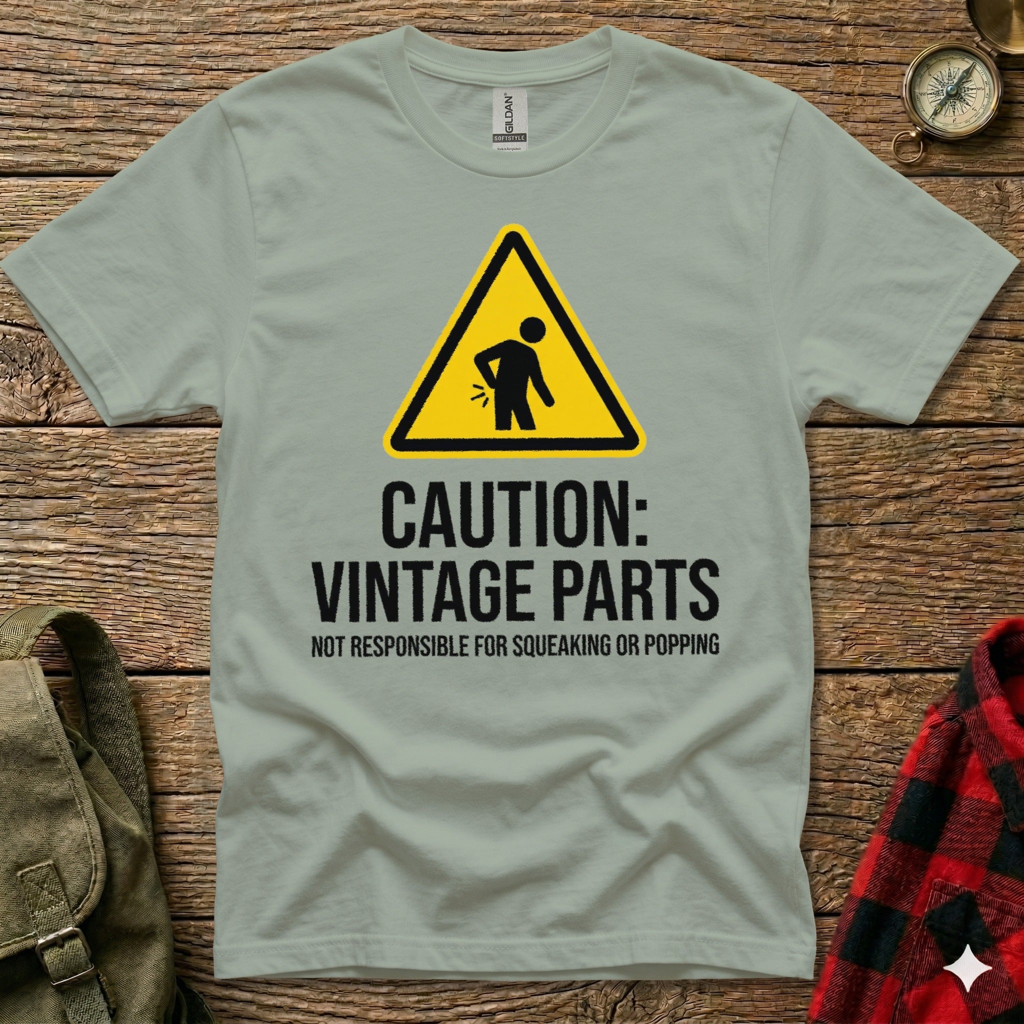 Grey t-shirt with black text and caution sign about vintage parts.